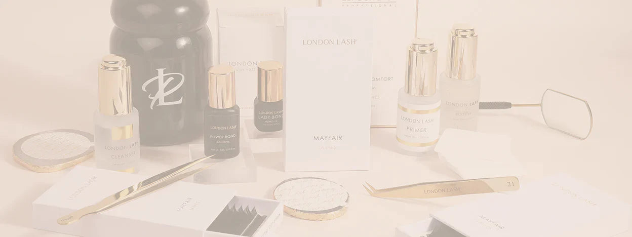 different tools for eyelash extention including gold tweezers, glue stones, black glue bottles and pre-treatment bottles and cleaning materials for cleaning lash tools and tweezers