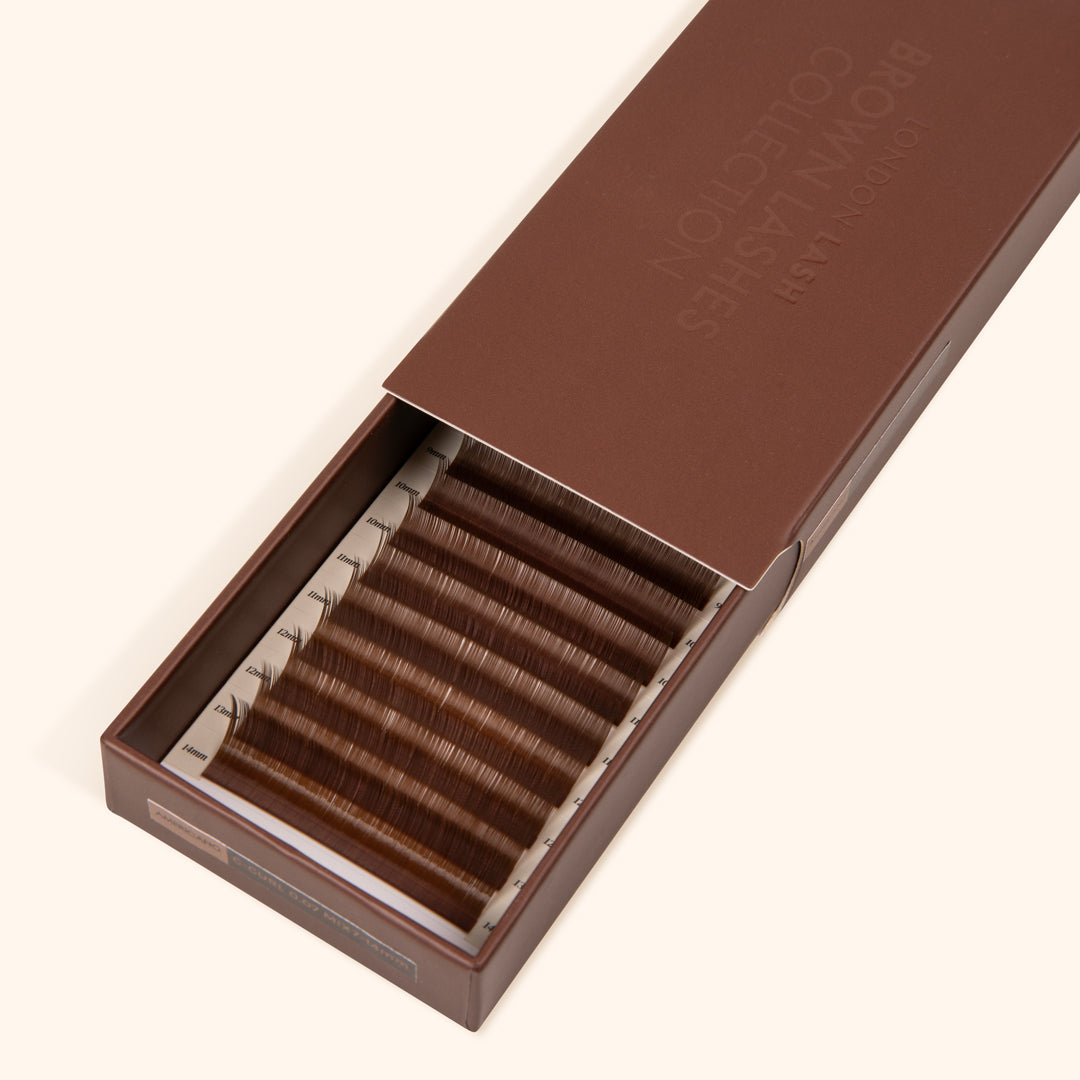 half open brown lash tray showing medium brown eyelash extensions