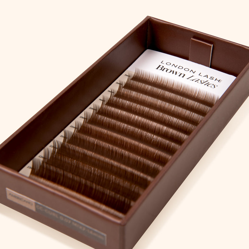 brown open eyelash extension tray with medium brown eyelash extension 