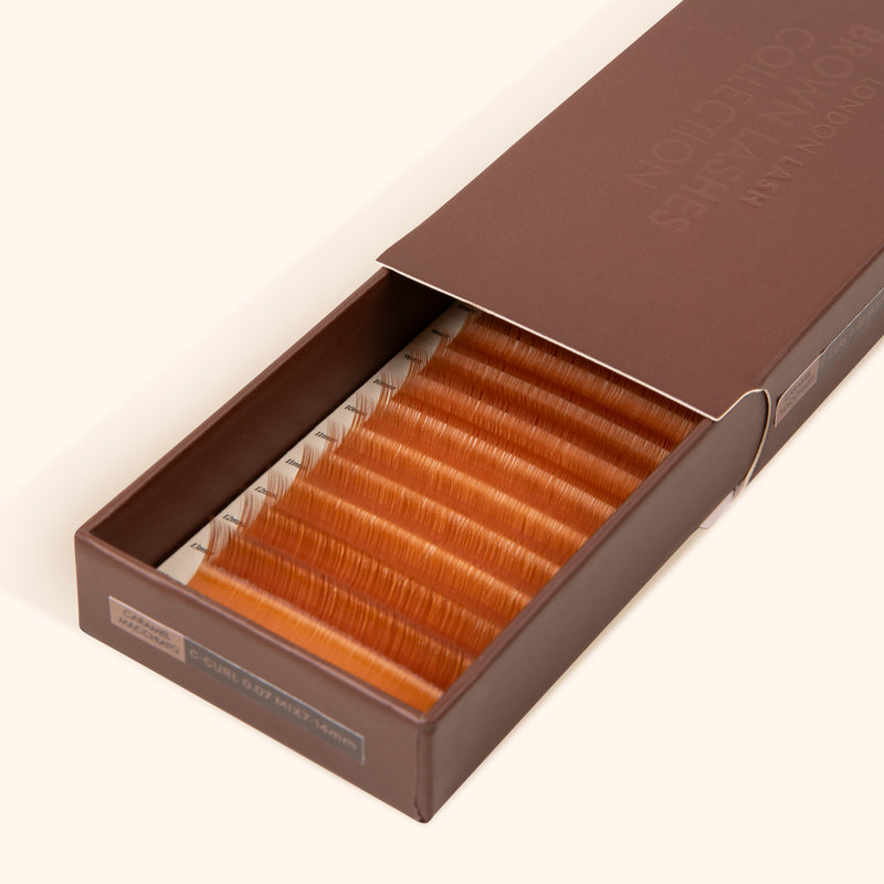 half open brown lash tray with ginger brown lash extensions inside